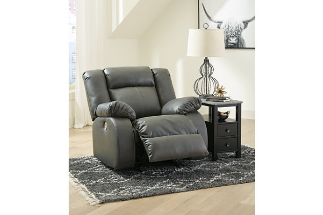 If highly contemporary looks and a heavenly feel sit well with you, rest your eyes on the Denoran power rocker recliner. Decadently soft, the easy-care faux leather upholstery is enriched with jumbo contrast stitching and dramatic cut-and-sew lines for fashion-forward flair. Radius cut arm frame adds cool, curvaceous interest. At your fingertips: one-touch power control with a zero-draw USB plug-in that’s not only convenient but also energy efficient. When it comes to high style at a down-to-earth price, this power recliner really brings it home.One-touch power control with adjustable positions and zero-draw USB plug-in | Zero-draw technology only consumes power when the USB receptacle is in use | Gentle rocking motion | Vinyl/polyester/polyurethane upholstery | Corner-blocked frame with metal reinforced seat | Attached back and seat cushions | High-resiliency foam cushions wrapped in thick poly fiber | Power cord included; UL Listed | Exaggerated headrest