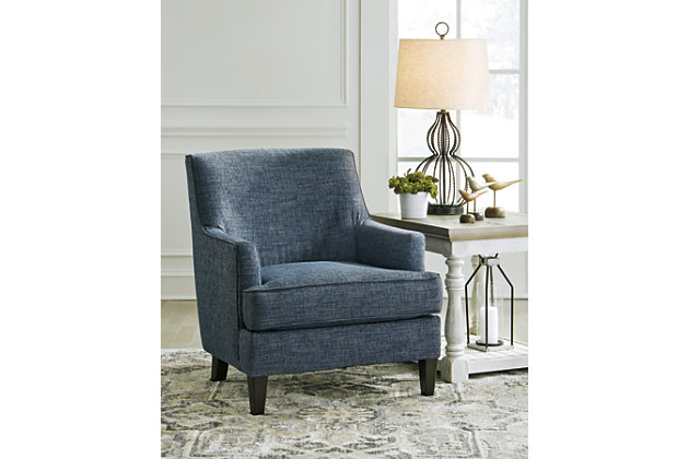 Simply striking and abundantly comfortable, the Tenino accent chair in indigo blue masters the art of everyday elegance. Whether your design aesthetic is contemporary, mid-century inspired or modern farmhouse, what a welcome addition with exceptional versatility.Corner-blocked frame | Attached back and loose seat cushions | High-resiliency foam cushions wrapped in thick poly fiber | Polyester upholstery | Exposed legs with faux wood finish