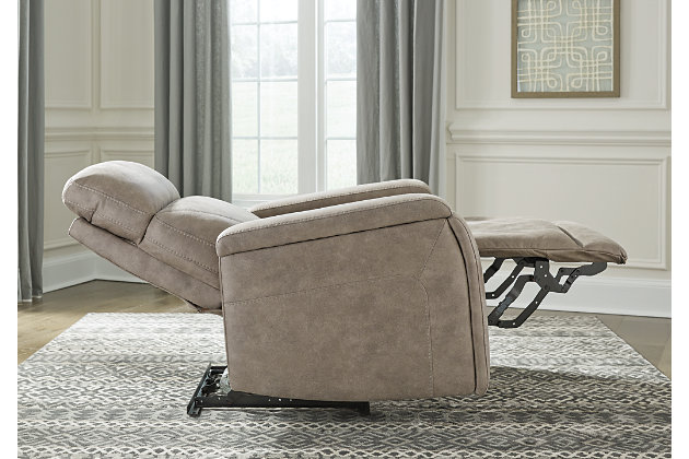 Inspired by luxury automotive interiors, the Rowlett power recliner is just where you want to be when it’s time to downshift for the day. Loaded with comfort and streamlined for high style, this decidedly modern power recliner in fashion-forward faux leather cradles you from head to toe. The one-touch power control puts comfort—and convenience—at your fingertips with features including an Easy View™ adjustable headrest, power lumbar support and zero draw USB plug-in for energy efficiency. And how’s this for a nice surprise: hidden cup holders (with magnetic locking system) to maximize the minimalism of this sleek recliner.One-touch power control with adjustable positions, Easy View™ adjustable headrest, power lumbar support and zero-draw USB plug-in | Zero-draw technology only consumes power when the USB receptacle is in use | Polyester/polyurethane upholstery | Corner-blocked frame with metal reinforced seat | Attached back and seat cushions | High-resiliency foam cushions wrapped in thick poly fiber | Hidden cup holders with magnetic locking | Extended ottoman for enhanced comfort | Power cord included; UL Listed