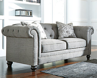 Classic Chesterfield tuxedo style is making a return, much to our pleasant surprise. And doesn’t the Ardenboro loveseat bring it back with newfound flair. A string of nailhead trim shows off the curves of the sumptuous rolled arms beautifully. Button tufted back with a deep diamond pattern is tailored to perfection.Corner-blocked frame | Attached back and reversible seat cushions | High-resiliency foam cushions wrapped in thick poly fiber | 2 decorative pillows included | Polyester upholstery; polyester/rayon and polyester toss pillows | Pillows with soft feather inserts; zippered access | Nailhead trim | Exposed feet with faux wood finish