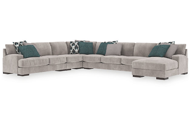 A feast for the eyes and pleasure for the senses, the Bardarson sectional is style and comfort taken to a higher level. Design elements including low track arms and low/wide feet give this sumptuous sectional ultra-contemporary appeal, while deep seats with reversible UltraPlush cushioning and designer feather-filled toss pillows are indulgently comfortable. The plush silvery gray upholstery hits just the right note if you’re looking for a richly neutral sectional that simply goes with everything.Includes 5 pieces: right-arm facing corner chaise, left-arm facing loveseat, armless chair, wedge and armless sofa | "Left-arm" and "right-arm" describe the position of the arm when you face the piece | Corner-blocked frame | Loose back and seat cushions | Reversible UltraPlush cushions remain loftier longer | 2 layers of cushioned comfort: high-density foam core encased in thick polyfill | 9 accent pillows included | Pillows with feather inserts and hidden zippers | Polyester/polyurethane upholstery; polyester and polyester/polyurethane pillows | Exposed feet with faux wood finish | Estimated Assembly Time: 20 Minutes