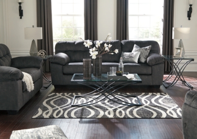 Looking for the perfect blend of decadent comfort and contemporary flair? Feast your eyes on the Accrington sofa. Tufted box cushioning and thick pillow top armrests brilliantly merge style and a sumptuous feel. Wonderfully plush to the touch, the sofa's granite gray fabric is the ultimate choice for a chic, trendy look.Corner-blocked frame | Attached back and loose seat cushions | High-resiliency foam cushions wrapped in thick poly fiber | Platform foundation system resists sagging 3x better than spring system after 20,000 testing cycles by providing more even support | Smooth platform foundation maintains tight, wrinkle-free look without dips or sags that can occur over time with sinuous spring foundations | Polyester upholstery | Exposed feet with faux wood finish
