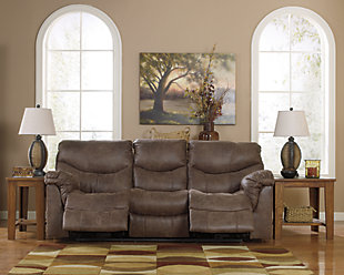 Crafted to fit like a glove and cradle you in comfort, the Alzena reclining sofa is just the right blend of tough and tender—offering the look of weathered leather you treasure, with the luxurious feel of supple suede that never gets old. Stylish details such as jumbo stitching—along with a split back for extra lumbar support and double-stuffed armrests—complete this fine faux leather piece.Pull tab reclining motion | Corner-blocked frame with metal reinforced seat | Attached back and seat cushions | High-resiliency foam cushions wrapped in thick poly fiber | Polyester/polyurethane upholstery