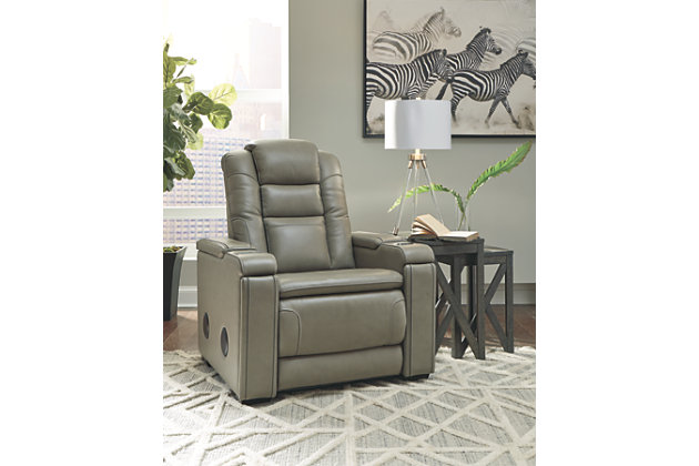Power up with the ultra-modern Boerna power recliner. Inspired by sports car interiors, the seating area is covered in real leather for your pleasure. An advanced one-touch power control puts everything at your fingertips, including an Easy View™ power headrest, USB port and wireless charging for your phone. If that’s not enough, how does this sound? Integrated wireless speakers, armrests with storage, and pull-out compartments to keep cup holders out of sight yet right at hand.One-touch power control with Easy View™ power adjustable headrest, USB charging and wireless phone charging | Wireless charger accommodates later model smartphones, including Apple iPhone, Samsung Galaxy, Huawei Mate and Nokia Lumia | Wireless speakers for surround sound listening pleasure | Corner-blocked frame with metal reinforced seat | Attached cushions | High-resiliency foam cushions wrapped in thick poly fiber | Leather interior upholstery; vinyl/polyester exterior upholstery | Each armrest includes storage compartment | Hidden base compartments revealing stainless steel cup holders (removable for easy cleaning) | Extended ottoman for enhanced comfort | Power cord included; UL Listed | Estimated Assembly Time: 15 Minutes