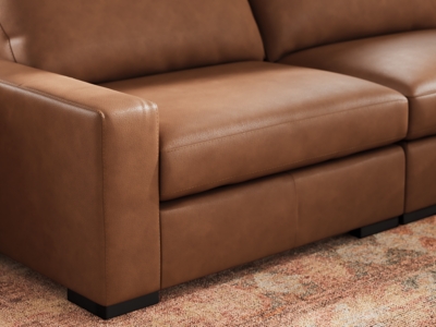 Close-up of leather arm and cushion of the sectional