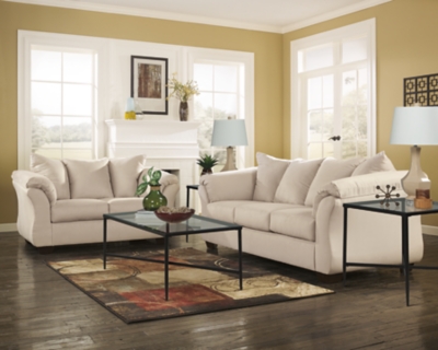 Talk about fine lines and great curves. That’s the beauty of the Darcy sofa—made to suit your appreciation for clean, contemporary style. A striking flared frame, comfy pillow top armrests and an ultra-soft upholstery that holds up to everyday living complete this fashion statement.High-resiliency foam cushions wrapped in thick poly fiber | Polyester upholstery | Loose seat and attached back and armrest cushions | Exposed feet with faux wood finish | Corner-blocked frame | Excluded from promotional discounts and coupons
