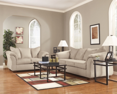 Talk about fine lines and great curves. That’s the beauty of the Darcy sofa—made to suit your appreciation for clean, contemporary style. A striking flared frame, comfy pillow top armrests and an ultra-soft upholstery that holds up to everyday living complete this fashion statement.High-resiliency foam cushions wrapped in thick poly fiber | Polyester upholstery | Loose seat and attached back and armrest cushions | Exposed feet with faux wood finish | Corner-blocked frame | Excluded from promotional discounts and coupons