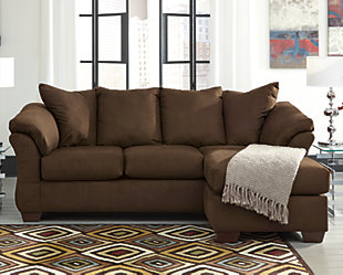 Talk about fine lines and great curves. That’s the beauty of the Darcy sofa chaise—made to suit your appreciation for clean, contemporary style. A striking flared frame, comfy pillow top armrests and an ultra-soft upholstery that holds up to everyday living complete this fashion statement. Versatile chaise has a movable ottoman and reversible cushion and can be used on right or left side.Corner-blocked frame | Loose seat and attached back and armrest cushions | High-resiliency foam cushions wrapped in thick poly fiber | Polyester upholstery | Exposed feet with faux wood finish | Chaise can be positioned on either side (thanks to reversible seat cushion and movable ottoman) | Excluded from promotional discounts and coupons