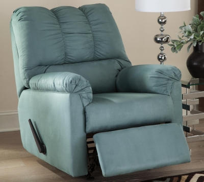 Talk about fine lines and great curves. That’s the beauty of the Darcy rocker recliner—made to suit your appreciation for clean, contemporary style. Comfy pillow top armrests, refined stitching and ultra-soft upholstery complete this fashion statement. Sky blue upholstery is a refreshing change from everyday ordinary reclining furniture.Reclining chair with gentle rocking motion | Attached back, seat and armrest cushions | High-resiliency foam cushions wrapped in thick poly fiber | Divided back cushion styling with puckered tailoring | Polyester upholstery in sky blue | Chair with one-pull reclining motion | Corner-blocked frame with metal reinforced seat | Excluded from promotional discounts and coupons