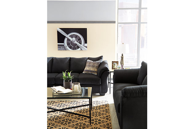 Talk about fine lines and great curves. That’s the beauty of the Darcy sofa—made to suit your appreciation for clean, contemporary style. A striking flared frame, comfy pillow top armrests and an ultra-soft upholstery that holds up to everyday living complete this fashion statement.Corner-blocked frame | Loose seat and attached back and armrest cushions | High-resiliency foam cushions wrapped in thick poly fiber | Polyester upholstery | Exposed feet with faux wood finish | Excluded from promotional discounts and coupons