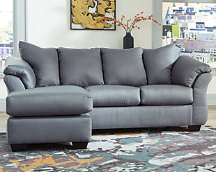 Talk about fine lines and great curves. That’s the beauty of the Darcy sofa chaise—made to suit your appreciation for clean, contemporary style. A striking flared frame, comfy pillow top armrests and an ultra-soft upholstery that holds up to everyday living complete this fashion statement. Versatile chaise has a movable ottoman and reversible cushion and can be used on right or left side.Corner-blocked frame | Loose seat and attached back and armrest cushions | High-resiliency foam cushions wrapped in thick poly fiber | Polyester upholstery | Exposed feet with faux wood finish | Chaise can be positioned on either side (thanks to reversible seat cushion and movable ottoman) | Excluded from promotional discounts and coupons