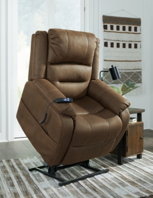 Enjoy comfort to the max in the Whitehill power lift recliner. After sitting and relaxing or snoozing in a fully reclined position, it eases you upright and back on your feet with the touch of a button. Dual motor capability lets you recline back and elevate your legs independently for custom comfort positioning. With USB charging at your fingertips, you can power up electronic devices as you unwind. The heavyweight padded faux leather has long-lasting durability, and its neutral chocolate hue complements most color schemes, so it looks as good as it feels.One-touch (hand control) power button with adjustable positions | Corner-blocked frame with metal seat box | Attached back and seat cushions | High-resiliency foam cushions wrapped in thick poly fiber | Polyester upholstery | Dual motors control the footrest and back independently for custom comfort positioning | USB charging | Power cord included; UL Listed | Estimated Assembly Time: 30 Minutes