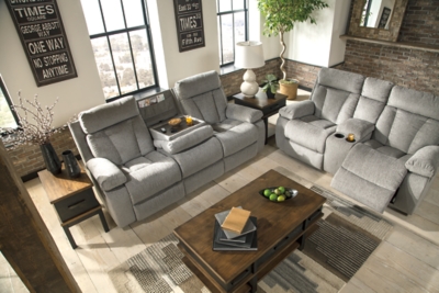 Bring your snacks and beverages and plan for a night with your feet up. This double reclining loveseat is plush in all the right places, and will support you longer than you can binge watch your favorite TV show. The neutral upholstery is ready for a patterned throw blanket and some of your time. Hide the remote in the console and claim your spot on the Mitchiner.Dual-sided recliner | Pull tab reclining motion | Corner-blocked frame with metal reinforced seat | Attached back and seat cushions | High-resiliency foam cushion wrapped in thick poly fiber | Polyester upholstery | Lift-top storage console and 2 cup holders