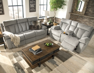 Your to-do list is complete, now it’s time for ultimate relaxation. This double reclining sofa is plush in all the right places, and will support you longer than you can binge watch your favorite TV show. The neutral upholstery is ready for a patterned throw pillow and some of your time. The middle seat’s back drops down into convenient table top with cup holders, the perfect resting spot for tablets and magazines.Dual-sided recliner; middle seat remains stationary | Drop-down center table with 2 cup holders | Pull tab reclining motion | Corner-blocked frame with metal reinforced seat | Attached back and seat cushions | High-resiliency foam cushion wrapped in thick poly fiber | Polyester upholstery