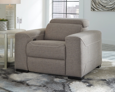 The challenge: Design a cutting-edge power recliner you’d never guess was a recliner. Super sleek and streamlined, the Mabton power recliner in taupe gray with high-contrast jumbo stitching might just be our best-kept secret. Rest assured, you’d be hard-pressed to find a modern recliner that looks so high end yet is so comfortably priced. Integrated elements include an Easy View™ adjustable headrest that offers low-profile style when it’s down and a high level of comfort when you’re kicking back and reclining. Factor in a one-touch power control (with a USB port) placed on the inside track arm, and you have the makings for one beautifully deceptive piece of furniture.One-touch power control with adjustable positions, Easy View™ adjustable headrest and USB plug-in | Corner-blocked frame | Attached cushions | High-resiliency foam cushions wrapped in thick poly fiber | Soft textured polyester upholstery | Power cord included; UL Listed | Exposed black feet | Estimated Assembly Time: 15 Minutes