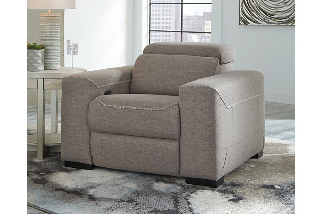 The challenge: design a cutting-edge power recliner you’d never guess was a recliner. Super sleek and streamlined, the Mabton power recliner in a taupe gray padded velvet might just be our best-kept secret. Rest assured, you’d be hard-pressed to find a modern recliner that looks so high end yet is so comfortably priced. Integrated elements include an Easy View™ adjustable headrest for low-profile style when it’s down and a high level of comfort when you’re kicking back and reclining. Factor in a one-touch power control (with a USB port) placed on the inside track arm, and you have the makings for one beautifully deceptive piece of furniture.One-touch power control with adjustable positions, Easy View™ adjustable headrest and USB plug-in | Corner-blocked frame | Attached cushions | High-resiliency foam cushions wrapped in thick poly fiber | Polyester upholstery | Power cord included; UL Listed | Exposed black feet | Estimated Assembly Time: 15 Minutes