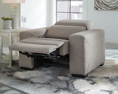 The challenge: Design a cutting-edge power recliner you’d never guess was a recliner. Super sleek and streamlined, the Mabton power recliner in taupe gray with high-contrast jumbo stitching might just be our best-kept secret. Rest assured, you’d be hard-pressed to find a modern recliner that looks so high end yet is so comfortably priced. Integrated elements include an Easy View™ adjustable headrest that offers low-profile style when it’s down and a high level of comfort when you’re kicking back and reclining. Factor in a one-touch power control (with a USB port) placed on the inside track arm, and you have the makings for one beautifully deceptive piece of furniture.One-touch power control with adjustable positions, Easy View™ adjustable headrest and USB plug-in | Corner-blocked frame | Attached cushions | High-resiliency foam cushions wrapped in thick poly fiber | Soft textured polyester upholstery | Power cord included; UL Listed | Exposed black feet | Estimated Assembly Time: 15 Minutes