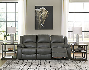 Sleek and streamlined, the Calderwell reclining sofa draws out your leisure time with its bustle back construction and thickly cushioned armrests. The super soft faux leather gets a high-end tweak with jumbo contrast stitching so you don’t have to sacrifice style for comfort. Sink into the comfortably supportive cushions and stretch your evening as long as you can.Dual-sided recliner; middle seat remains stationary | Pull tab reclining motion | Corner-blocked frame | Attached cushions | High-resiliency foam cushions wrapped in thick poly fiber | Vinyl/polyester/polyurethane upholstery | Estimated Assembly Time: 15 Minutes