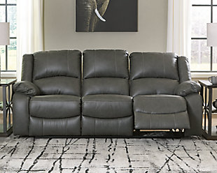 Sleek and streamlined, the Calderwell reclining sofa draws out your leisure time with its bustle back construction and thickly cushioned armrests. The super soft faux leather gets a high-end tweak with jumbo contrast stitching so you don’t have to sacrifice style for comfort. Sink into the comfortably supportive cushions and stretch your evening as long as you can.Dual-sided recliner; middle seat remains stationary | Pull tab reclining motion | Corner-blocked frame | Attached cushions | High-resiliency foam cushions wrapped in thick poly fiber | Vinyl/polyester/polyurethane upholstery | Estimated Assembly Time: 15 Minutes