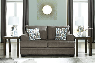 The contemporary Dorsten loveseat has comfort written all over it. From the plush cushions to the textured gray fabric, it’s a total winner for relaxation. The patterned throw pillows in blue, brown and tan complement the richly neutral upholstery.Corner-blocked frame | Attached back and loose seat cushions | High-resiliency foam cushions wrapped in thick poly fiber | 2 decorative pillows included | Pillows with soft polyfill | Polyester upholstery and pillows | Exposed feet with faux wood finish | Platform foundation system resists sagging 3x better than spring system after 20,000 testing cycles by providing more even support | Smooth platform foundation maintains tight, wrinkle-free look without dips or sags that can occur over time with sinuous spring foundations