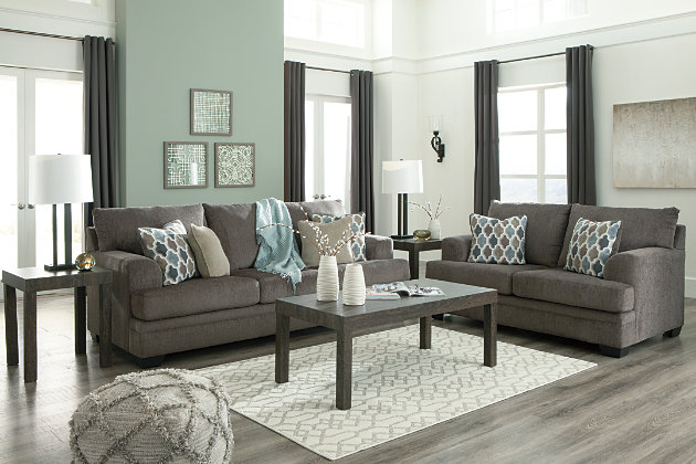 The contemporary Dorsten sofa has comfort written all over it. From the plush cushions to the textured gray fabric, it’s a total winner for relaxation. Designer throw pillows in blue, brown and tan complement the richly neutral upholstery.Corner-blocked frame | Attached back and loose seat cushions | High-resiliency foam cushions wrapped in thick poly fiber | 4 decorative pillows included | Pillows with soft polyfill | Polyester upholstery and pillows | Exposed feet with faux wood finish | Platform foundation system resists sagging 3x better than spring system after 20,000 testing cycles by providing more even support | Smooth platform foundation maintains tight, wrinkle-free look without dips or sags that can occur over time with sinuous spring foundations