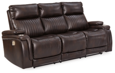 If you agree it’s time to put the high design in recline, prepare to be impressed with the Team Time power reclining sofa in chocolate brown. Equipped with everything from a power adjustable headrest and USB charging ports, to stainless steel cup holders and chic padded armrests, it’s the clear winner for contemporary style and comfort. Ultra-cool vertical channel stitching, jumbo contrast stitching and a pad-on-pad arm design put this power reclining sofa in a class by itself.Dual-sided recliner | One-touch power control with Easy View™ power adjustable headrest and USB plug-in | Corner-blocked frame with metal reinforced seat | Attached cushions | 42" high back | Drop-down table with 2 cup holders and a magazine holder | Stainless steel cup holder on each armrest | High-resiliency foam cushions wrapped in thick poly fiber | Polyester/polyurethane (faux leather) upholstery | Extended ottoman for enhanced comfort | Power cord included; UL Listed | Estimated Assembly Time: 15 Minutes