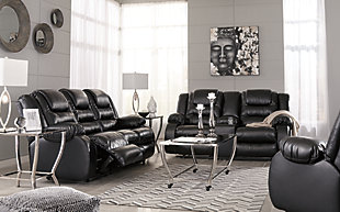 When it comes to comfort, style and value, the Vacherie faux leather reclining loveseat in black rocks. Tailored for feel-good flair, its fashion-forward bustle back design is enhanced with sculpted padding on the headrest for cradling support. Channel cushioning along the sides flows into thick, wrapped pillowtop armrests that are truly over the top. And while it might look like you broke the bank, a sumptuously soft leather-like fabric keeps indulgence well within budget.Dual-sided recliner | Pull tab reclining motion | Corner-blocked frame with metal reinforced seat | Attached back and seat cushions | High-resiliency foam cushions wrapped in thick poly fiber | Lift-top storage console and 2 cup holders | Vinyl/polyester/polyurethane upholstery