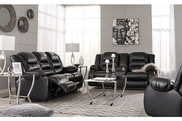 When it comes to comfort, style and value, the Vacherie faux leather reclining loveseat in black rocks. Tailored for feel-good flair, its fashion-forward bustle back design is enhanced with sculpted padding on the headrest for cradling support. Channel cushioning along the sides flows into thick, wrapped pillowtop armrests that are truly over the top. And while it might look like you broke the bank, a sumptuously soft leather-like fabric keeps indulgence well within budget.Dual-sided recliner | Pull tab reclining motion | Corner-blocked frame with metal reinforced seat | Attached back and seat cushions | High-resiliency foam cushions wrapped in thick poly fiber | Lift-top storage console and 2 cup holders | Vinyl/polyester/polyurethane upholstery