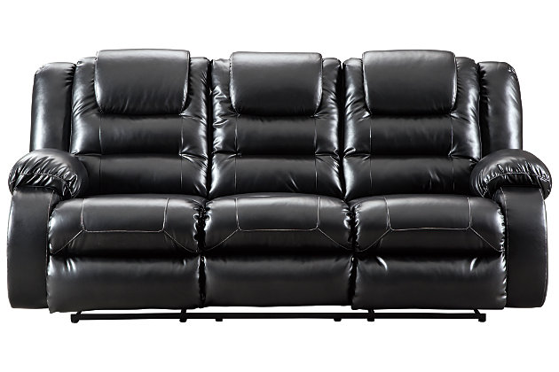 When it comes to comfort, style and value, the Vacherie faux leather reclining sofa in black rocks. Tailored for feel-good flair, its fashion-forward bustle back design is enhanced with sculpted padding on the headrest for cradling support. Channel cushioning along the sides flows into thick, wrapped pillowtop armrests that are truly over the top. And while it might look like you broke the bank, a sumptuously soft leather-like fabric keeps indulgence well within budget.Dual-sided recliner; middle seat remains stationary | Pull tab reclining motion | Corner-blocked frame with metal reinforced seat | Attached back and seat cushions | High-resiliency foam cushions wrapped in thick poly fiber | Vinyl/polyester/polyurethane upholstery