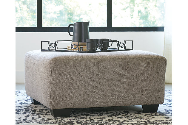 Celebrate strength and durability in design with the Ballinasloe oversized accent ottoman. Neutral color opens doors for you to use your imagination with accessorizing the room. Softly textured chenille cushion sports stylish versatility. Throw up your feet or use it as a table for a show-stopping tray. It’s all up to you.Corner-blocked frame | High-resiliency foam cushion wrapped in thick poly fiber | Polyester upholstery | Exposed feet with faux wood finish