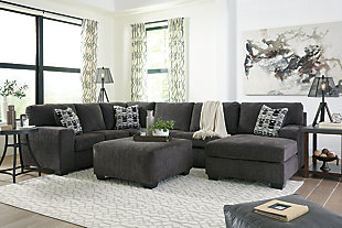 A mastery in less is more, the Ballinasloe sectional with ottoman manages to make cool, contemporary design so warm and cozy. A new twist on neutral, the sectional’s soothing “smoky” gray upholstery is incredibly plush to the touch. Gently rounded corners give the clean-lined profile a sense of ease, for a high-style look that’s ultra inviting. Rest assured, an oversized ottoman gives everyone plenty of room to kick up their heels, or use with a tray for easy entertaining.Includes 3-piece sectional (right-arm facing corner chaise, armless loveseat and left-arm facing sofa) and an oversized ottoman | Left-arm and "right-arm" describe the position of the arm when you face the piece | Corner-blocked frame | Attached back and loose seat cushions | Firmly cushioned ottoman | High-resiliency foam cushions wrapped in thick poly fiber | Accent pillows included | Pillows with soft polyfill | Polyester upholstery and pillows | Exposed feet with faux wood finish | Estimated Assembly Time: 10 Minutes