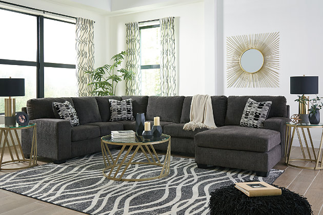 A mastery in less is more, the Ballinasloe sectional manages to make cool, contemporary design so warm and cozy. A new twist on neutral, the sectional’s soothing “smoky” gray upholstery is incredibly plush to the touch. Gently rounded corners give the clean-lined profile a sense of ease, for a high-style look that’s ultra inviting.Includes 3 pieces: right-arm facing corner chaise, armless loveseat and left-arm facing sofa | "Left-arm" and "right-arm" describe the position of the arm when you face the piece | Corner-blocked frame | Attached back and loose seat cushions | High-resiliency foam cushions wrapped in thick poly fiber | 3 toss pillows included | Pillows with soft polyfill | Polyester upholstery and pillows | Exposed feet with faux wood finish | Estimated Assembly Time: 10 Minutes