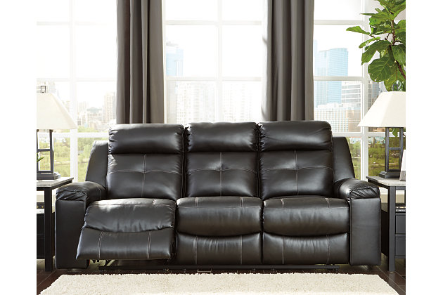 You don’t just want to recline. You want to recline in high design. Wrapped in a fabulous black faux leather upholstery, the Kempten reclining sofa with 42" high back is everything you long for—and then some. Ultra clean lines, subtle curves and sumptuous comfort make it a sight for sore eyes and tired muscles. Here’s the showstopper: ambient blue LED lighting along the sofa base for a movie theater experience enjoyed from the convenience of home.Dual-sided recliner; middle seat remains stationary | Tab pull reclining motion | Corner-blocked frame with metal reinforced seat | Attached cushions | High-resiliency foam cushions wrapped in thick poly fiber | Polyurethane upholstery | 42" high back | Ambient blue LED lighting on base for a theater-style experience | Power cord included; UL Listed | Estimated Assembly Time: 15 Minutes
