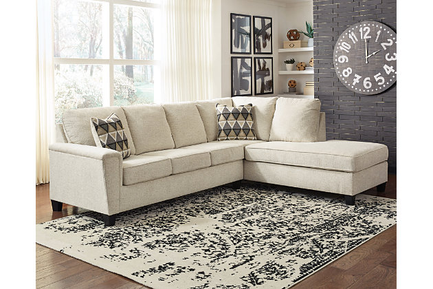 If you’re looking to lighten the mood, you’re sure to find the budget-conscious Abinger sectional beautifully fits the bill. Covered in a creme chenille upholstery loaded with plush texture, this less-is-more contemporary sectional is dressed to impress with angled side profiling and a track arm wrapped with a layer of pillowy softness for that little something extra. Open-ended chaise adds to this sectional’s swank look.Includes 2 pieces: right-arm facing corner chaise and left-arm facing sofa | “Left-arm” and "right-arm" describe the position of the arm when you face the piece | Corner-blocked frame | Attached back and loose seat cushions | High-resiliency foam cushions wrapped in thick poly fiber | Polyester upholstery | Throw pillows included | Pillows with soft polyfill | Exposed tapered feet | Platform foundation system resists sagging 3x better than spring system after 20,000 testing cycles by providing more even support | Smooth platform foundation maintains tight, wrinkle-free look without dips or sags that can occur over time with sinuous spring foundations | Estimated Assembly Time: 5 Minutes
