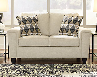 If you’re looking to lighten the mood, you’re sure to find the space-conscious, budget-conscious Abinger loveseat a breath of fresh air. Covered in a cream-tone chenille upholstery loaded with plush texture, this less-is-more contemporary loveseat is dressed to impress with angled side profiling and track armrests wrapped with a layer of pillowy softness for that little something extra. Crisp and clean, the 2-over-2 cushion styling adds up to one sensational look.Corner-blocked frame | Attached back and loose seat cushions | High-resiliency foam cushions wrapped in thick poly fiber | Polyester upholstery | 2 throw pillows included | Pillows with soft polyfill | Exposed feet with faux wood finish