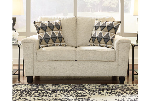 If you’re looking to lighten the mood, you’re sure to find the space-conscious, budget-conscious Abinger loveseat a breath of fresh air. Covered in a cream-tone chenille upholstery loaded with plush texture, this less-is-more contemporary loveseat is dressed to impress with angled side profiling and track armrests wrapped with a layer of pillowy softness for that little something extra. Crisp and clean, the 2-over-2 cushion styling adds up to one sensational look.Corner-blocked frame | Attached back and loose seat cushions | High-resiliency foam cushions wrapped in thick poly fiber | Polyester upholstery | 2 throw pillows included | Pillows with soft polyfill | Exposed feet with faux wood finish