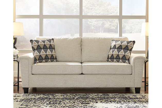 If you’re looking to lighten the mood, you’re sure to find the space-conscious, budget-conscious Abinger sofa a breath of fresh air. Covered in a cream-tone chenille upholstery loaded with plush texture, this less-is-more contemporary sofa is dressed to impress with angled side profiling and track armrests wrapped with a layer of pillowy softness for that little something extra. Crisp and clean, the 2-over-2 cushion styling adds up to one sensational look.Corner-blocked frame | Attached back and loose seat cushions | High-resiliency foam cushions wrapped in thick poly fiber | Polyester upholstery | 2 throw pillows included | Pillows with soft polyfill | Exposed feet with faux wood finish