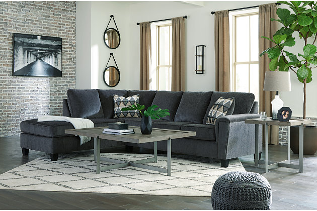 If you’re looking for a smokin' hot look priced to entice, you’re sure to find the budget-conscious Abinger sectional beautifully fits the bill. Covered in a smoke gray chenille upholstery loaded with plush texture, this less-is-more contemporary sectional is dressed to impress with angled side profiling and a track arm wrapped with a layer of pillowy softness for that little something extra. Open-ended chaise adds to this sectional’s swank look. Crafted of quality memory foam, a pull-out full mattress comfortably accommodates overnight guests.Includes 2 pieces: left-arm facing corner chaise and right-arm facing sofa sleeper | "Left-arm" and "right-arm" describe the position of the arm when you face the piece | Corner-blocked frame | Attached back and loose seat cushions | High-resiliency foam cushions wrapped in thick poly fiber | Polyester upholstery | Throw pillows included | Pillows with soft polyfill | Exposed tapered feet | Included bi-fold full memory foam mattress sits atop a supportive steel frame | Memory foam provides better airflow for a cooler night’s sleep | Memory foam encased in damask ticking | Estimated Assembly Time: 5 Minutes