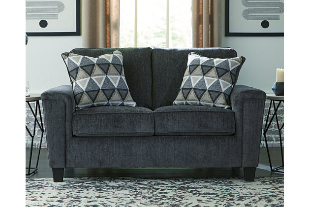 If you’re looking for a smokin’ hot look priced to entice, you’re sure to find the space-conscious, budget-conscious Abinger loveseat beautifully fits the bill. Covered in a smoke gray chenille upholstery loaded with plush texture, this less-is-more contemporary loveseat is dressed to impress with angled side profiling and track armrests wrapped with a layer of pillowy softness for that little something extra. Crisp and clean, the 2-over-2 cushion styling adds up to one sensational look.Corner-blocked frame | Attached back and loose seat cushions | High-resiliency foam cushions wrapped in thick poly fiber | Polyester upholstery | 2 throw pillows included | Pillows with soft polyfill | Exposed tapered feet