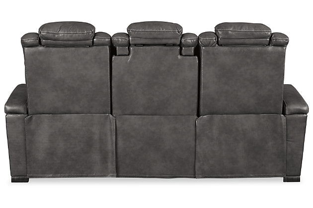 Looking for seating with all the bells and whistles? The Turbulance power reclining sofa has you covered. Get double the relaxation—recline your body then adjust your headrest. Pull down the middle seat to reveal a drop down table ready to hold your magazines and remotes. With USB charging ports, your devices will enjoy this sofa, too. Stainless steel cup holders accompany you on either side. All wrapped up in quality faux leather with fashion-forward jumbo stitching for a look and feel you’ll love.One-touch power control with adjustable positions | Easy View™ power adjustable headrests | Includes USB charging port in each power control | Corner-blocked frame with metal reinforced seat | Attached back and seat cushions | High-resiliency foam cushions wrapped in thick poly fiber | Vinyl/polyester upholstery | Drop-down center table with AC Power and 2 stainless steel cup holders | Hidden armrest storage compartments | Power cord included; UL Listed | Estimated Assembly Time: 15 Minutes