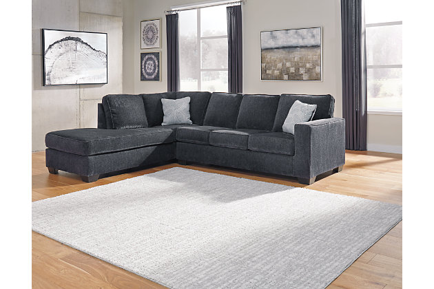 If style is the question, then the Altari 2-piece sectional with ottoman is the answer. Sporting clean lines and sleek track arms, the decidedly contemporary profile is enhanced with plump cushioning and a chenille-feel upholstery, so pleasing to the touch. Sure to play well with so many color schemes, this living room set in slate gray includes understated floral pattern pillows for fashionably fresh appeal.Includes 2-piece sectional (with left-arm facing corner chaise and right-arm facing sofa) and ottoman | Left-arm and "right-arm" describe the position of the arm when you face the piece | Corner-blocked frame | Attached back and loose seat cushions | Firmly cushioned ottoman | High-resiliency foam cushions wrapped in thick poly fiber | Decorative pillows included | Pillows with soft polyfill | Polyester upholstery and pillows | Exposed feet with faux wood finish | Sectional's platform foundation system resists sagging 3x better than spring system after 20,000 testing cycles by providing more even support | Smooth platform foundation maintains tight, wrinkle-free look without dips or sags that can occur over time with sinuous spring foundations | Estimated Assembly Time: 5 Minutes