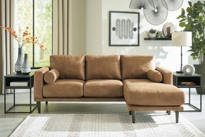 For a fresh spot in your space, turn to the Arroyo sofa chaise. This invigorating piece breathes warmth into your home with its striking caramel faux leather upholstery, modern bolster pillows and tapered legs. Wind down at the end of a long day and sink into this canyon of comfort.Corner-blocked frame | High-resiliency foam cushions wrapped in thick poly fiber | Loose cushions; reversible chaise cushion | Metal seat base | Polyester and polyurethane (faux leather) upholstery | Bolster pillows included | Pillows with soft polyfill | Exposed legs with faux wood finish | Minor assembly (simply attach legs) | Estimated Assembly Time: 15 Minutes