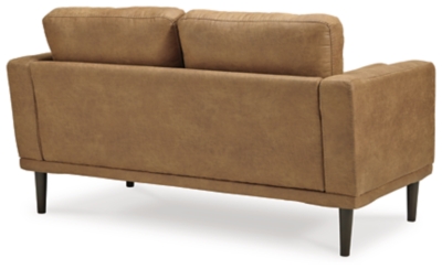 For a fresh spot in your space, turn to the Arroyo loveseat. This invigorating piece breathes warmth into your home with its striking caramel faux leather upholstery, modern bolster pillows and tapered legs. Wind down at the end of a long day when you sink into this canyon of comfort.Corner-blocked frame | High-resiliency foam cushions wrapped in thick poly fiber | Non-reversible loose seat and back cushions | Metal seat base | Polyester and polyurethane (faux leather) upholstery | 2 bolster pillows | Exposed legs with faux wood finish | Minor assembly (simply attach legs) | Estimated Assembly Time: 15 Minutes