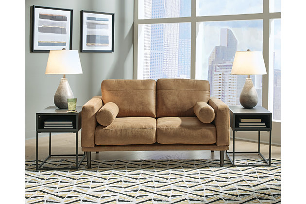 For a fresh spot in your space, turn to the Arroyo loveseat. This invigorating piece breathes warmth into your home with its striking caramel faux leather upholstery, modern bolster pillows and tapered legs. Wind down at the end of a long day when you sink into this canyon of comfort.Corner-blocked frame | High-resiliency foam cushions wrapped in thick poly fiber | Non-reversible loose seat and back cushions | Metal seat base | Polyester and polyurethane (faux leather) upholstery | 2 bolster pillows | Exposed legs with faux wood finish | Minor assembly (simply attach legs) | Estimated Assembly Time: 15 Minutes