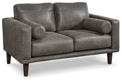 For a fresh spot in your space, turn to the Arroyo designer loveseat. This invigorating piece breathes warmth into your home with its striking gray faux leather upholstery and tapered legs. Wind down at the end of a long day when you sink into this canyon of comfort.Corner-blocked frame | High-resiliency foam cushions wrapped in thick poly fiber | Non-reversible loose seat and back cushions | Metal seat base | Polyester/polyurethane upholstery | 2 bolster pillows | Exposed legs with faux wood finish | Minor assembly (simply attach legs) | Estimated Assembly Time: 15 Minutes