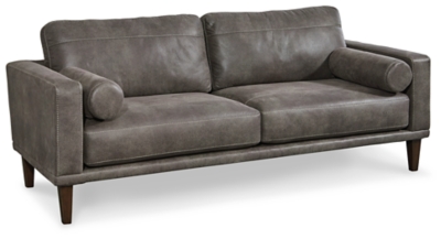 For a fresh spot in your space, turn to the Arroyo designer sofa. This invigorating piece breathes warmth into your home with its striking gray faux leather upholstery, modern bolster pillows and tapered legs. Wind down at the end of a long day when you sink into this canyon of comfort.Corner-blocked frame | High-resiliency foam cushions wrapped in thick poly fiber | Non-reversible loose seat and back cushions | Metal seat base | Polyester/polyurethane upholstery | 2 bolster pillows | Exposed legs with faux wood finish | Minor assembly (simply attach legs) | Estimated Assembly Time: 15 Minutes