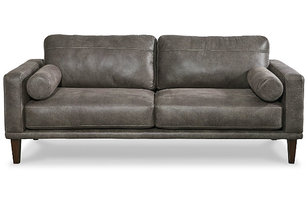 For a fresh spot in your space, turn to the Arroyo designer sofa. This invigorating piece breathes warmth into your home with its striking gray faux leather upholstery, modern bolster pillows and tapered legs. Wind down at the end of a long day when you sink into this canyon of comfort.Corner-blocked frame | High-resiliency foam cushions wrapped in thick poly fiber | Non-reversible loose seat and back cushions | Metal seat base | Polyester/polyurethane upholstery | 2 bolster pillows | Exposed legs with faux wood finish | Minor assembly (simply attach legs) | Estimated Assembly Time: 15 Minutes