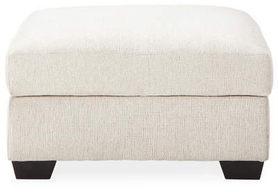 Let it snow. Doubling your pleasure with its combination of form and function, the Cambri storage ottoman in a snow-tone chenille fabric invites you to stretch your style in an easy-elegant way. Whether your aesthetic is urban hip or suburban chic, this posh ottoman with removable cushioned top and loads of handy storage is sure to look and feel right at home. And how’s this for a welcome surprise: a built-in tabletop with cup holders on the flip side!Corner-blocked frame | High-resiliency foam cushion wrapped in thick poly fiber | Polyester upholstery | Storage under cushioned removable top | Built-in tabletop/cup holders on reverse side of removable cushion | Exposed legs with faux wood finish