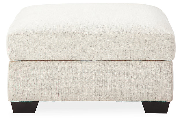 Let it snow. Doubling your pleasure with its combination of form and function, the Cambri storage ottoman in a snow-tone chenille fabric invites you to stretch your style in an easy-elegant way. Whether your aesthetic is urban hip or suburban chic, this posh ottoman with removable cushioned top and loads of handy storage is sure to look and feel right at home. And how’s this for a welcome surprise: a built-in tabletop with cup holders on the flip side!Corner-blocked frame | High-resiliency foam cushion wrapped in thick poly fiber | Polyester upholstery | Storage under cushioned removable top | Built-in tabletop/cup holders on reverse side of removable cushion | Exposed legs with faux wood finish