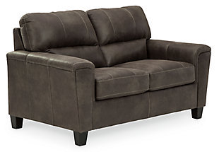 If you love the cool look of leather but long for the warm feel of fabric, you can take comfort in the Navi 2-piece set with sofa and loveseat. Wrapped in a fabulous faux leather with a weathered hue and hint of pebbly texture to resemble the real deal, this decidedly modern ensemble proves less is more. Elements include angled side profiling and track armrests wrapped with a layer of pillowy softness for that little something extra. Prominent jumbo stitching and clean-lined divided back styling lend fashion-forward flair.Includes 2 pieces: sofa and loveseat | Corner-blocked frame | Attached back and loose seat cushions | High-resiliency foam cushions wrapped in thick poly fiber | Faux leather upholstery  | Exposed feet with faux wood finish | Platform foundation system resists sagging 3x better than spring system after 20,000 testing cycles by providing more even support | Smooth platform foundation maintains tight, wrinkle-free look without dips or sags that can occur over time with sinuous spring foundations